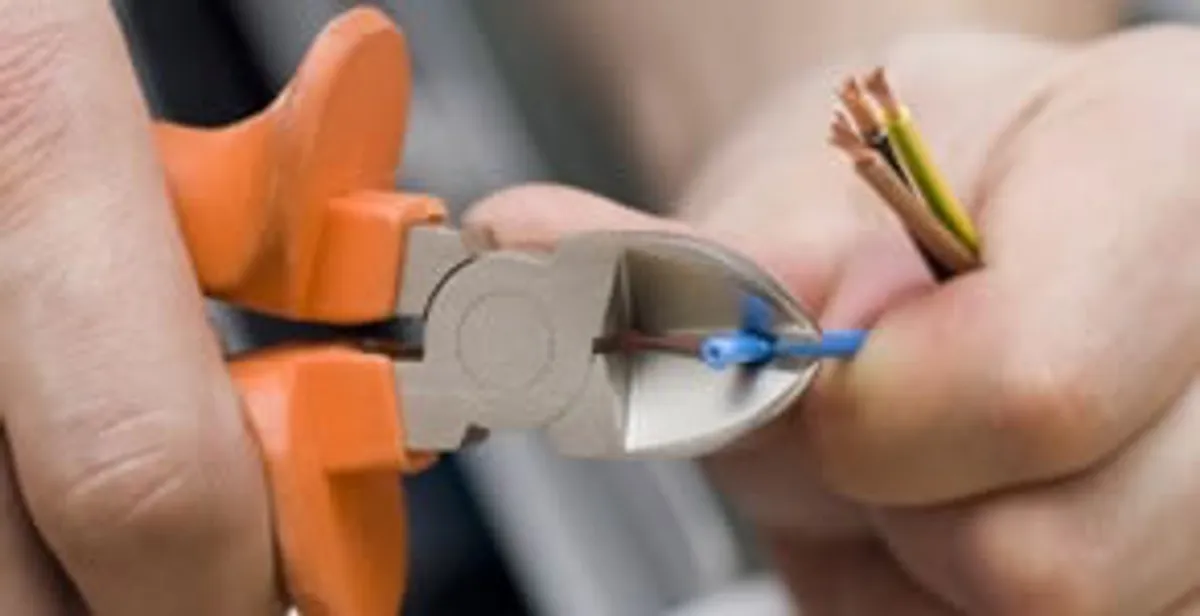 professional electrical services showing precise wire cutting by licensed electricians in Atlanta, GA